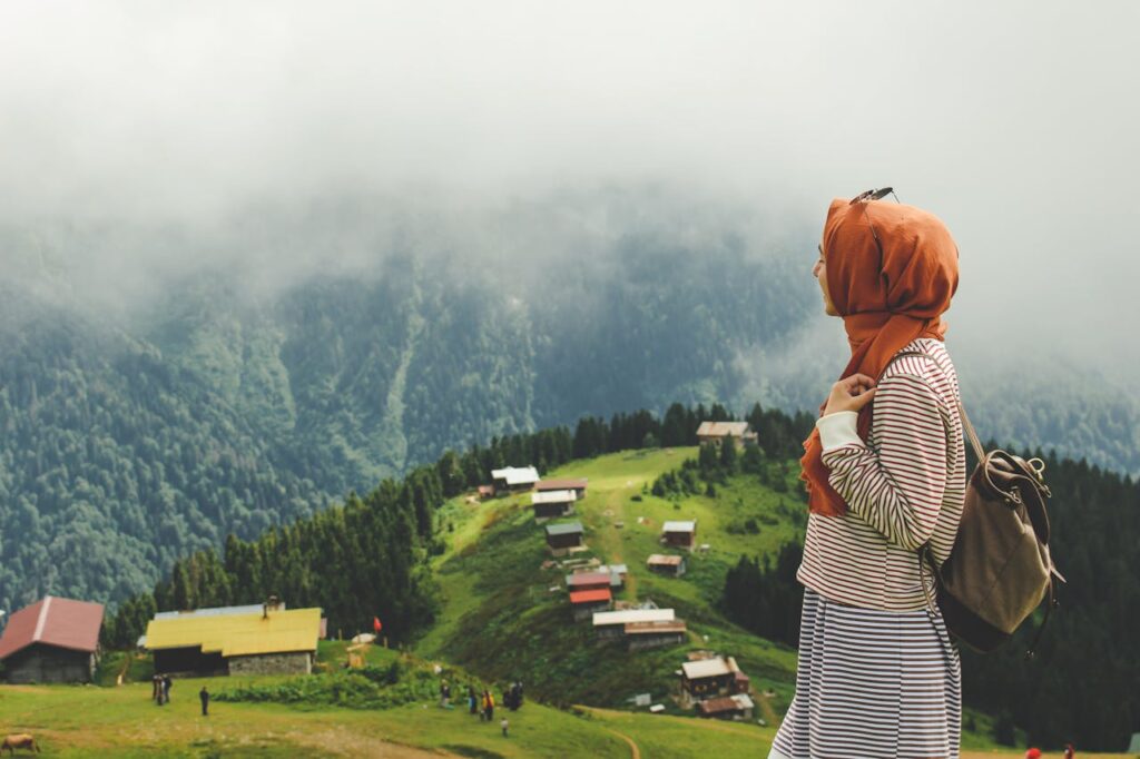 Woman in hijab enjoys panoramic view of Pokut Plateau, Rize, Turkey.